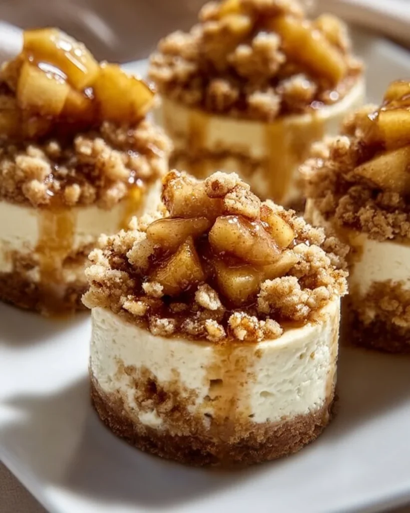 Delicious Apple Crisp Mini Cheesecakes topped with crumbly apple crisp